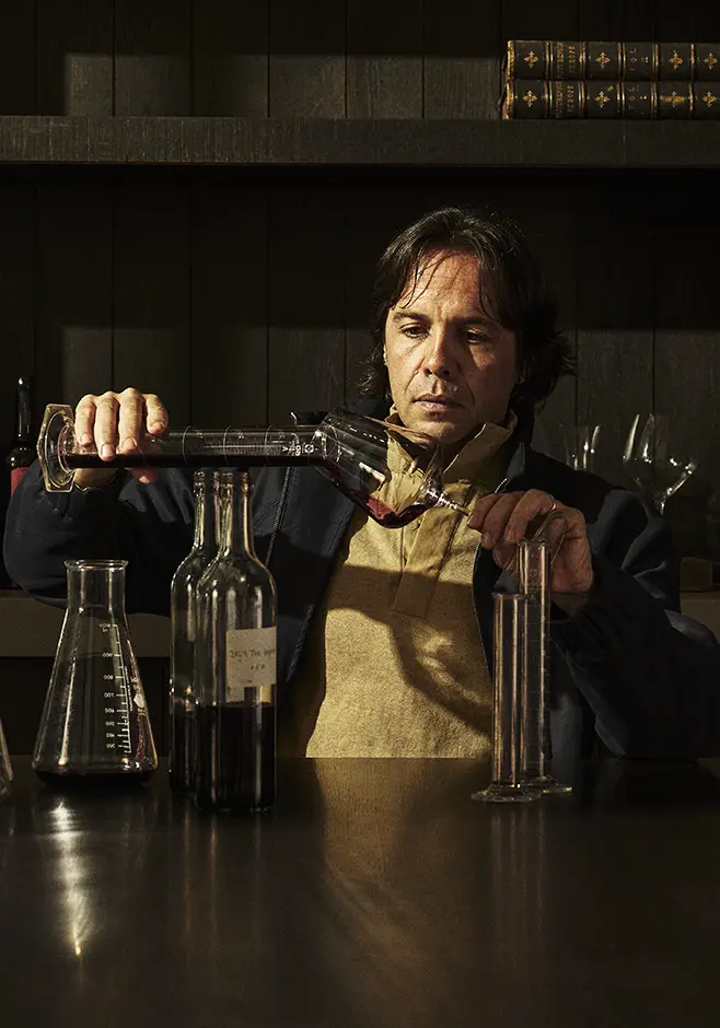 Monte Rosso Winemaker Bernadino Sani sitting at a table sampling wine.